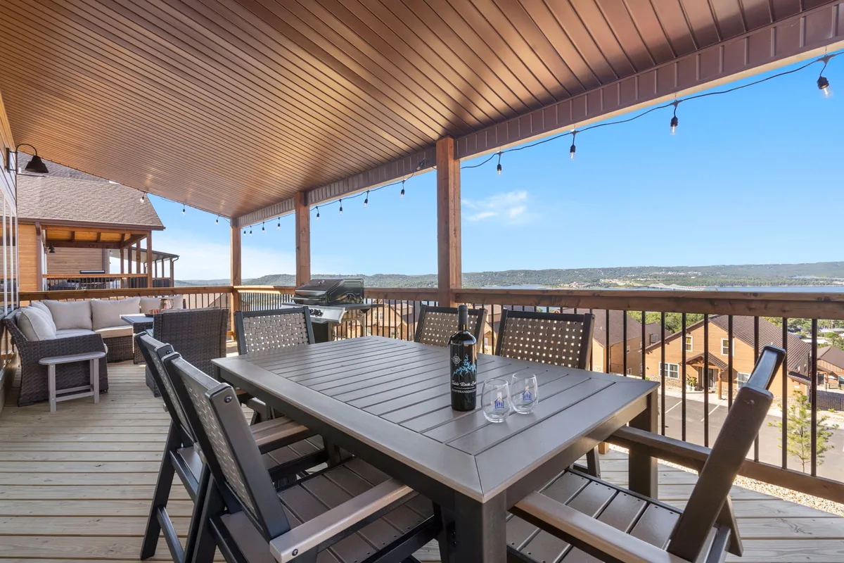 An inviting exterior dining area with a table and chairs overlooking a beautiful landscape. The relaxed atmosphere is ideal for gatherings, enjoying meals outdoors, and spending quality time with family and pets in the fresh air.